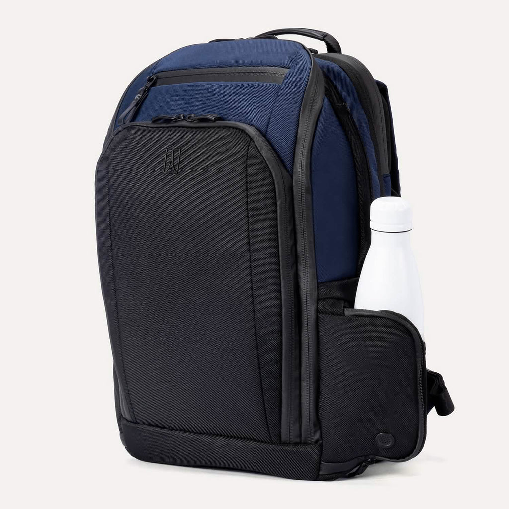 Front angled view of Travelpro Altitude All-Purpose Laptop Backpack in Aviator Navy, featuring top zip pocket and exterior bottle holder.
