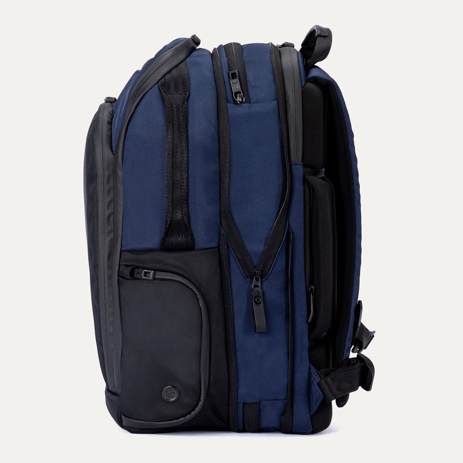 Side view of the expanded Travelpro Altitude All-Purpose Backpack in Aviator Navy, highlighting increased capacity and utility pocket.
