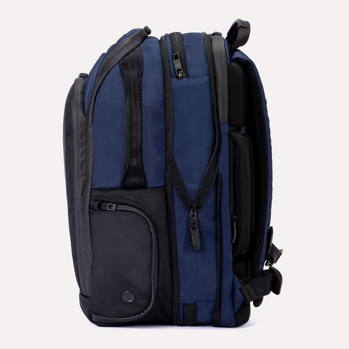 Side view of the expanded Travelpro Altitude All-Purpose Backpack in Aviator Navy, highlighting increased capacity and utility pocket.
