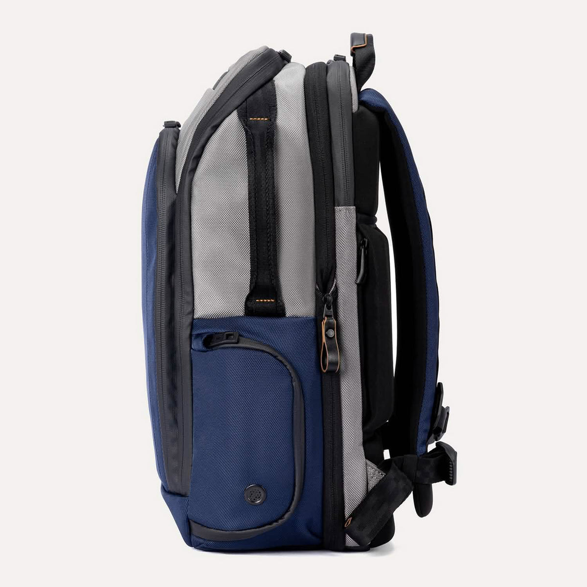Profile view of the Travelpro Altitude All-Purpose Backpack in Stellar Navy/Grey, featuring gear pocket and zippered side compartment.