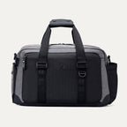 Front view of the Travelpro Altitude Day-to-Day Duffel in Falcon Grey, showing structured handles and front compression straps.
