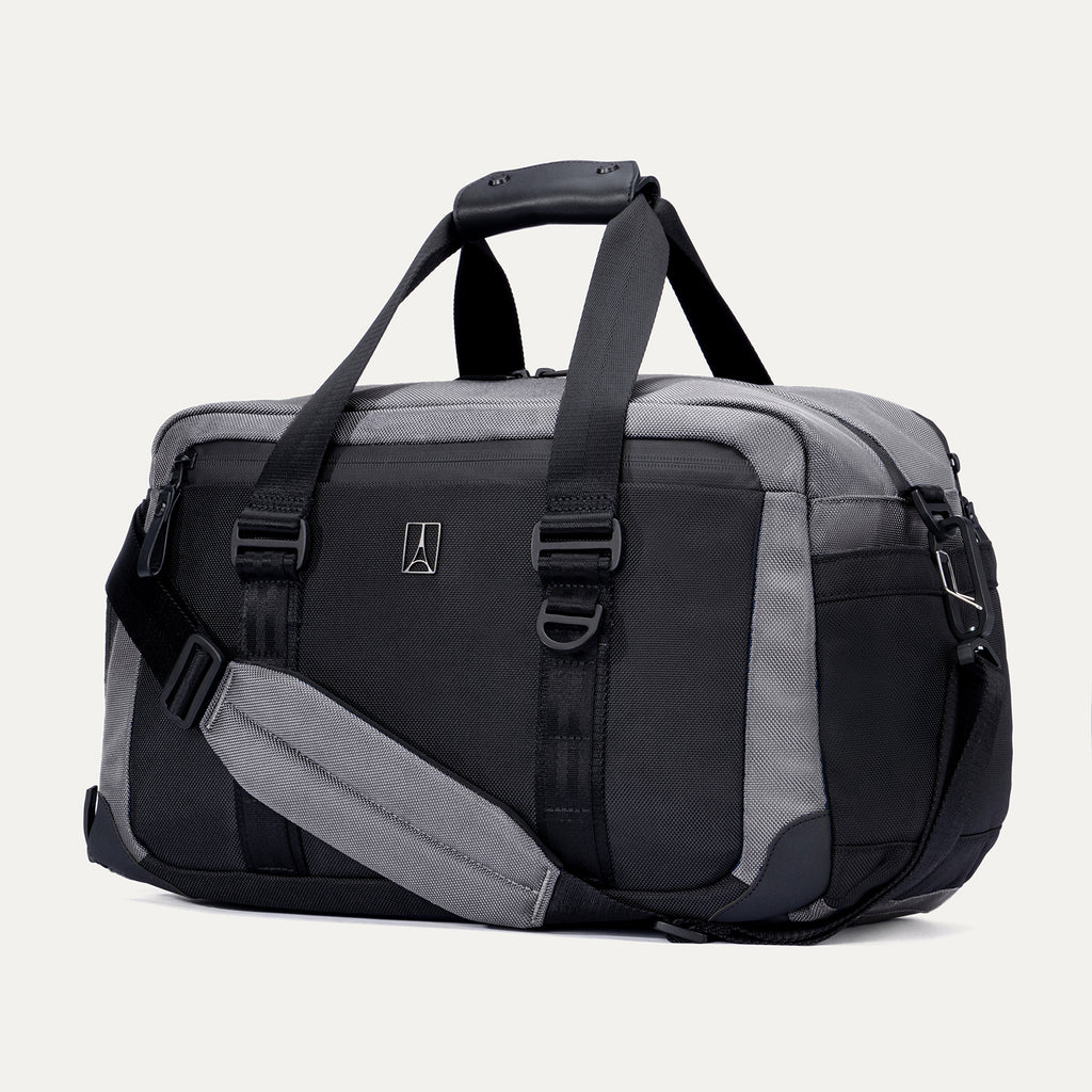 Angled front view of the Travelpro Altitude Day-to-Day Duffel in Falcon Grey, highlighting the zippered pocket and adjustable shoulder strap.

