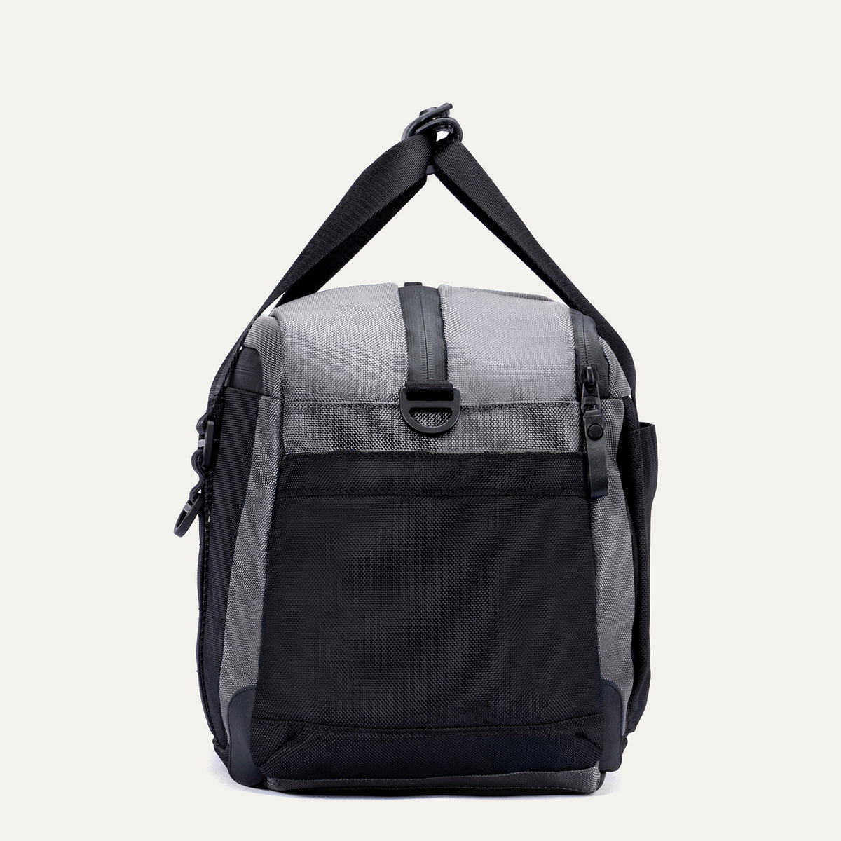 Side view of the Travelpro Altitude Day-to-Day Duffel in Falcon Grey, showing the adjustable shoulder strap and end pocket.
