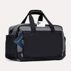 Rear view of the Travelpro Altitude Day-to-Day Duffel in Falcon Grey, showing passport and phone in quick-access exterior pocket.
