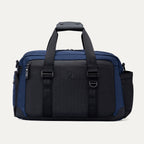 Front view of the Travelpro Altitude Day-to-Day Duffel in Aviator Navy, featuring daisy chain loops and dual zippered compartments.
