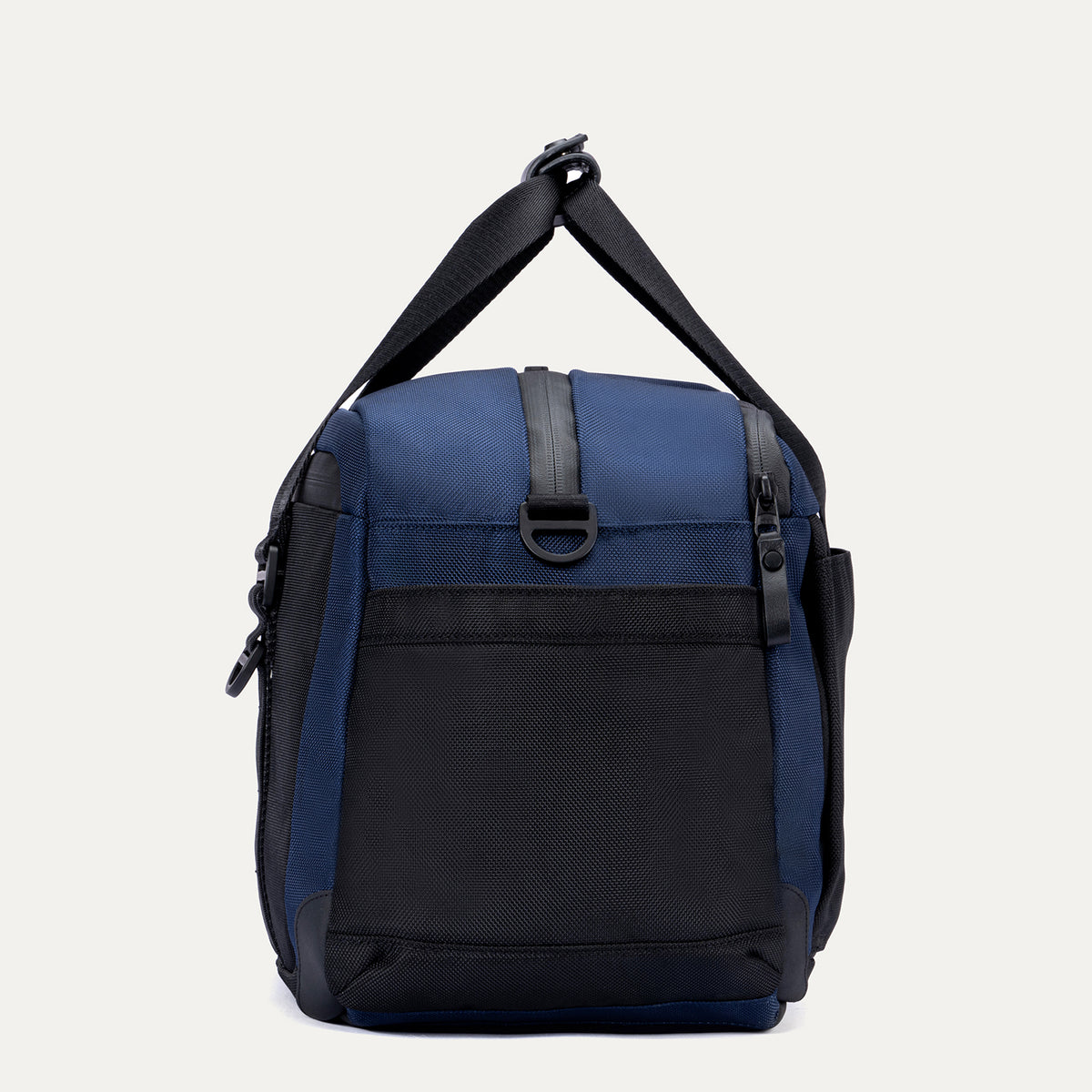 Side view of the Travelpro Altitude Day-to-Day Duffel in Aviator Navy, highlighting the zip pocket and adjustable shoulder strap.
