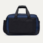 Rear view of the Travelpro Altitude Day-to-Day Duffel in Aviator Navy, featuring a large back panel pocket for secure storage.

