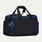 Rear view of the Travelpro Altitude Day-to-Day Duffel in Aviator Navy, showing phone and passport stored in exterior slip pockets.
