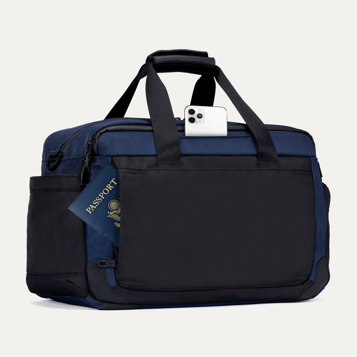 Rear view of the Travelpro Altitude Day-to-Day Duffel in Aviator Navy, showing phone and passport stored in exterior slip pockets.
