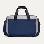 Rear view of the Travelpro Altitude Day-to-Day Duffel in Stellar Navy/Grey, showing rear pocket and dual carry handles.
