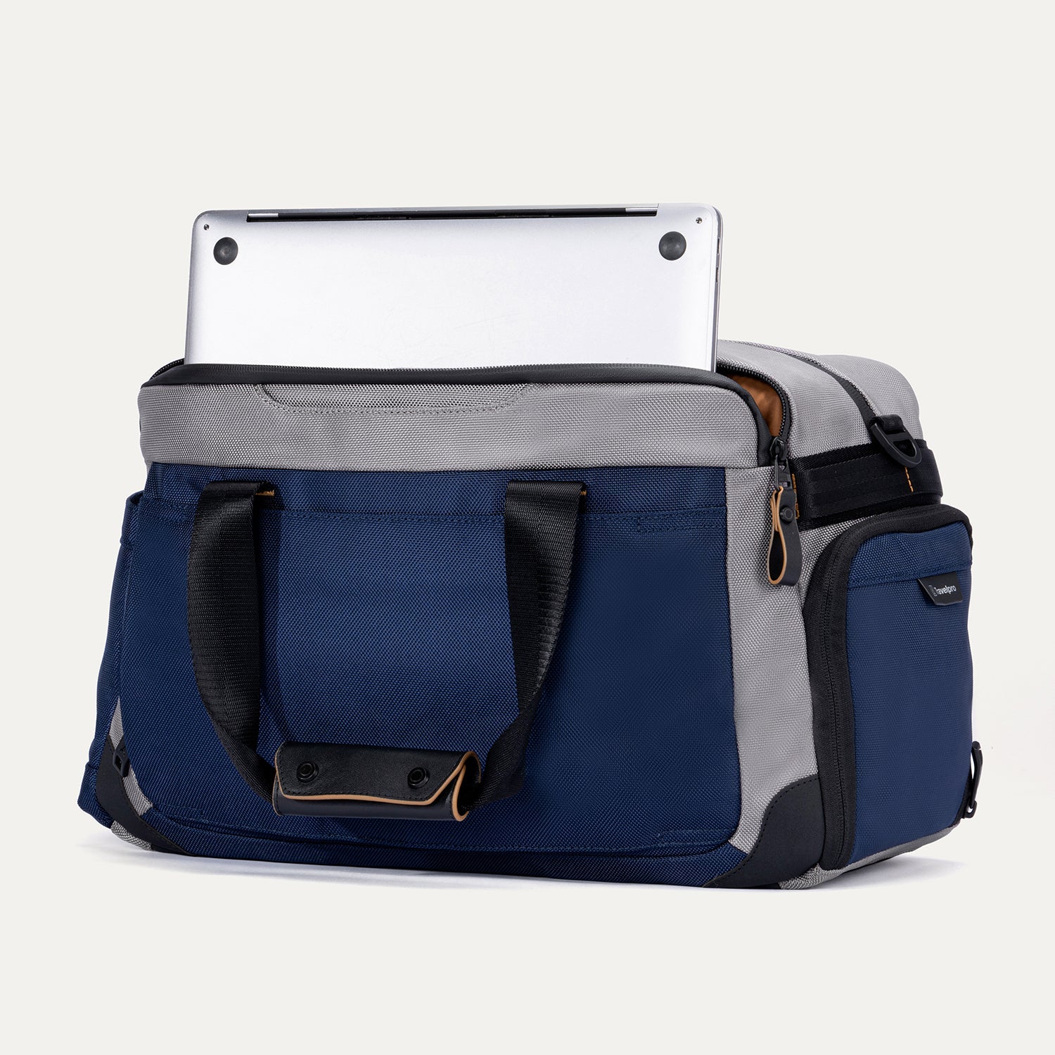 Rear angled view of the Travelpro Altitude Day-to-Day Duffel in Stellar Navy/Grey, showing laptop partially stored in padded sleeve.
