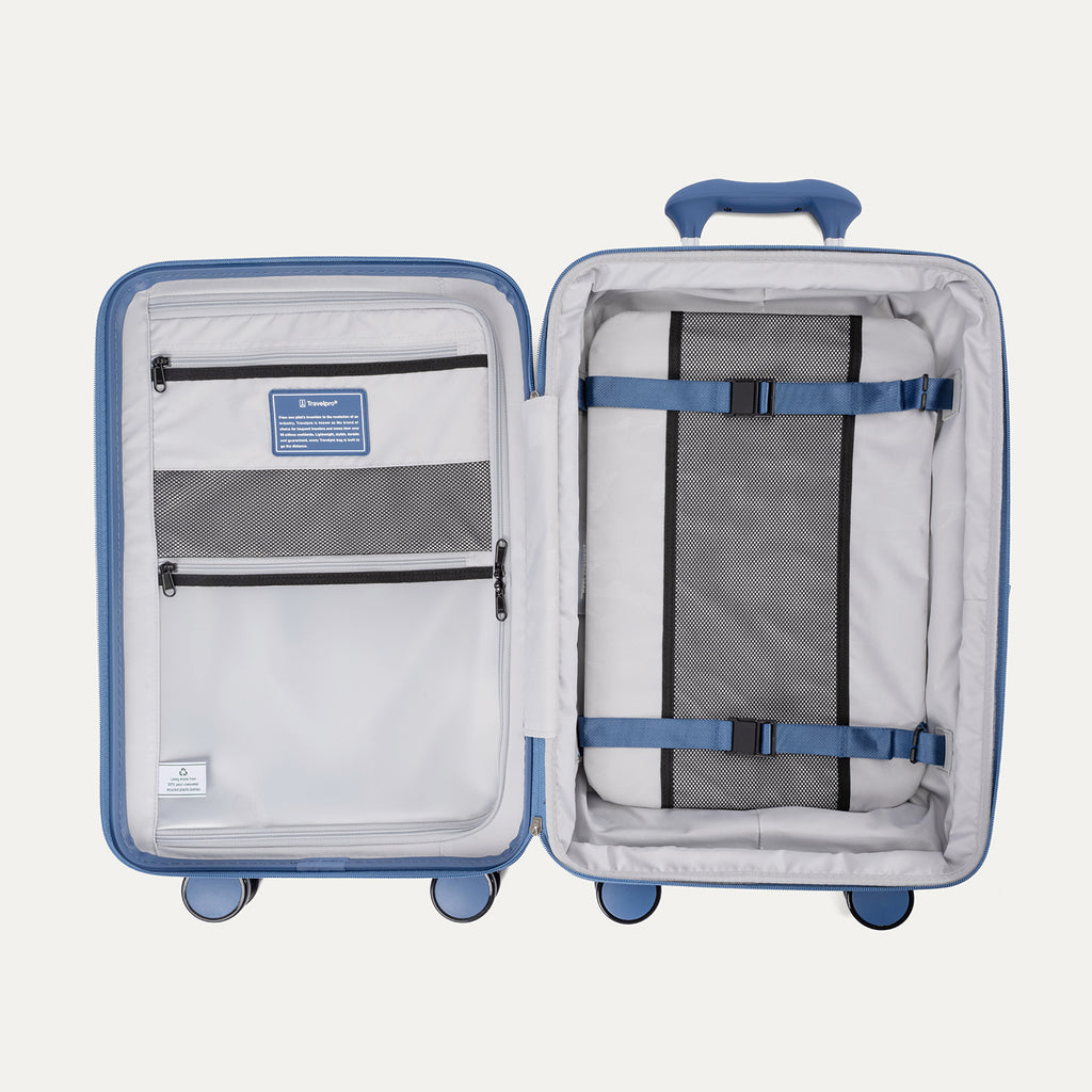 Open blue suitcase with interior organization panels on a white background
