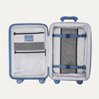 Open blue suitcase with interior organization panels on a white background
