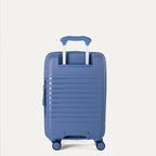 Rear view of the Optima Expandable Compact Carry-on Spinner in Horizon Blue, showcasing the durable polypropylene shell, the extended telescoping PowerScope handle, and smooth-rolling spinner wheels.