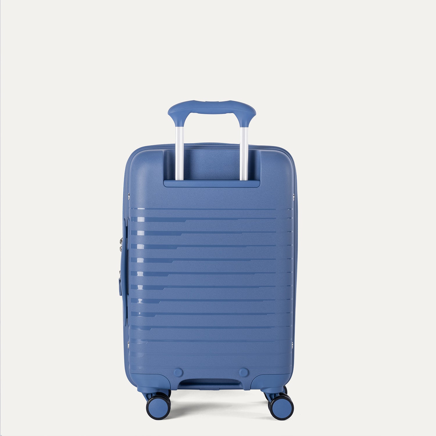 Rear view of the Optima Expandable Compact Carry-on Spinner in Horizon Blue, showcasing the durable polypropylene shell, the extended telescoping PowerScope handle, and smooth-rolling spinner wheels.