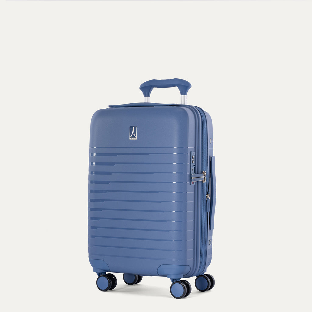 Three-quarter view of the Optima Expandable Compact Carry-on Spinner in Horizon Blue, showcasing the sleek, durable polypropylene hardshell design, horizontal ribbing, and smooth mobility on multi-directional spinner wheels.
