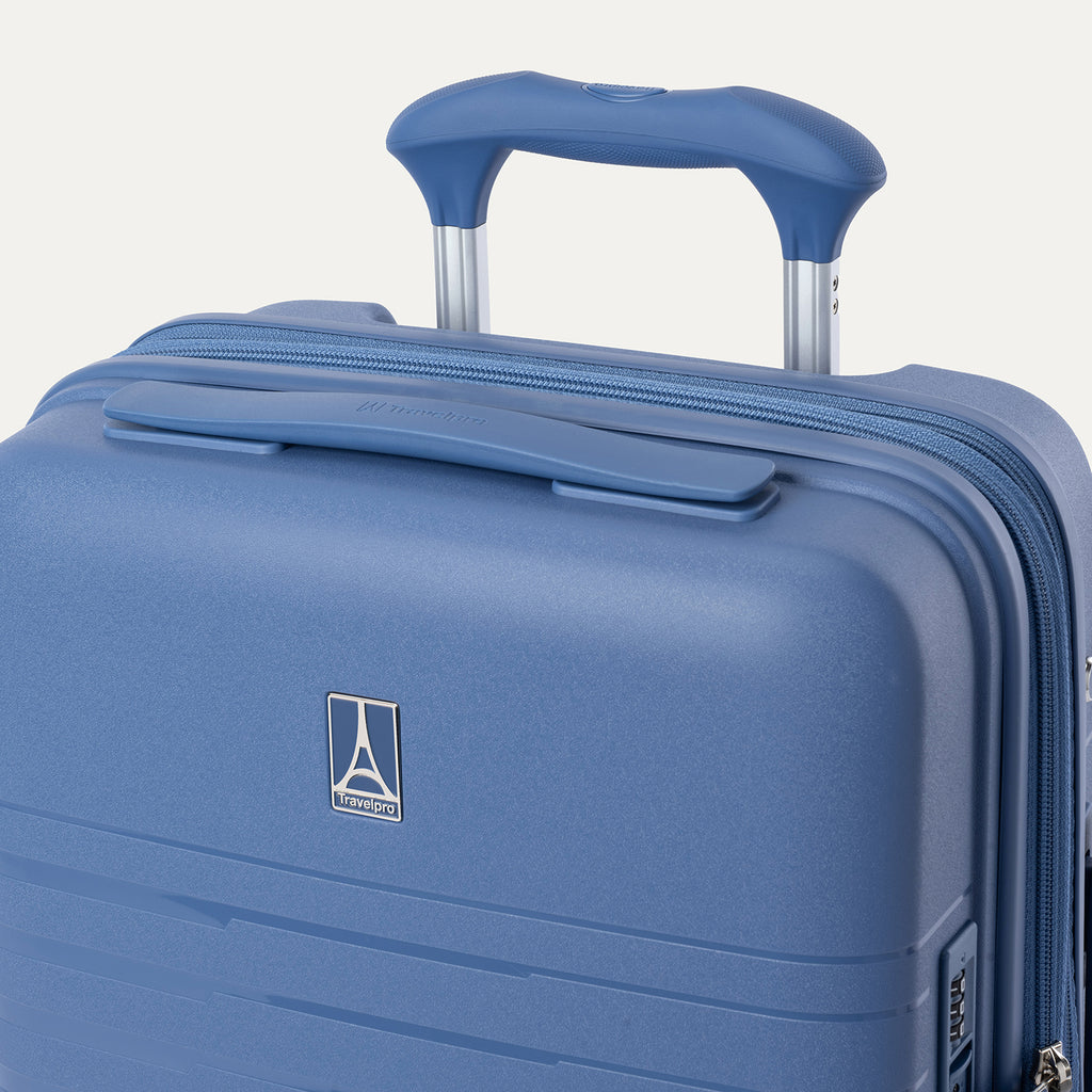 Blue suitcase with a handle on a light gray background