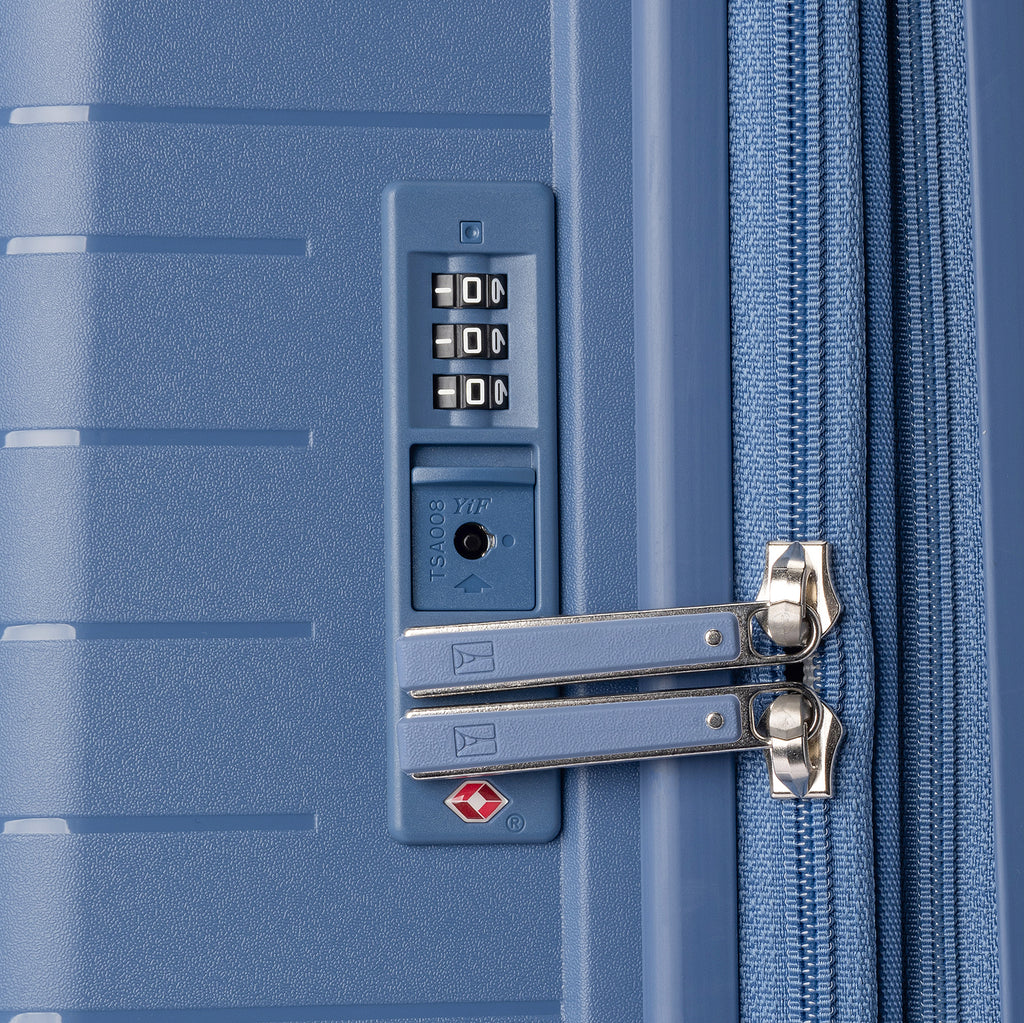 Close-up of a blue suitcase with a combination lock and zipper