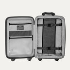 Open gray suitcase with interior organization panels on a light gray background