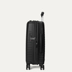 Black suitcase with wheels on a light gray background