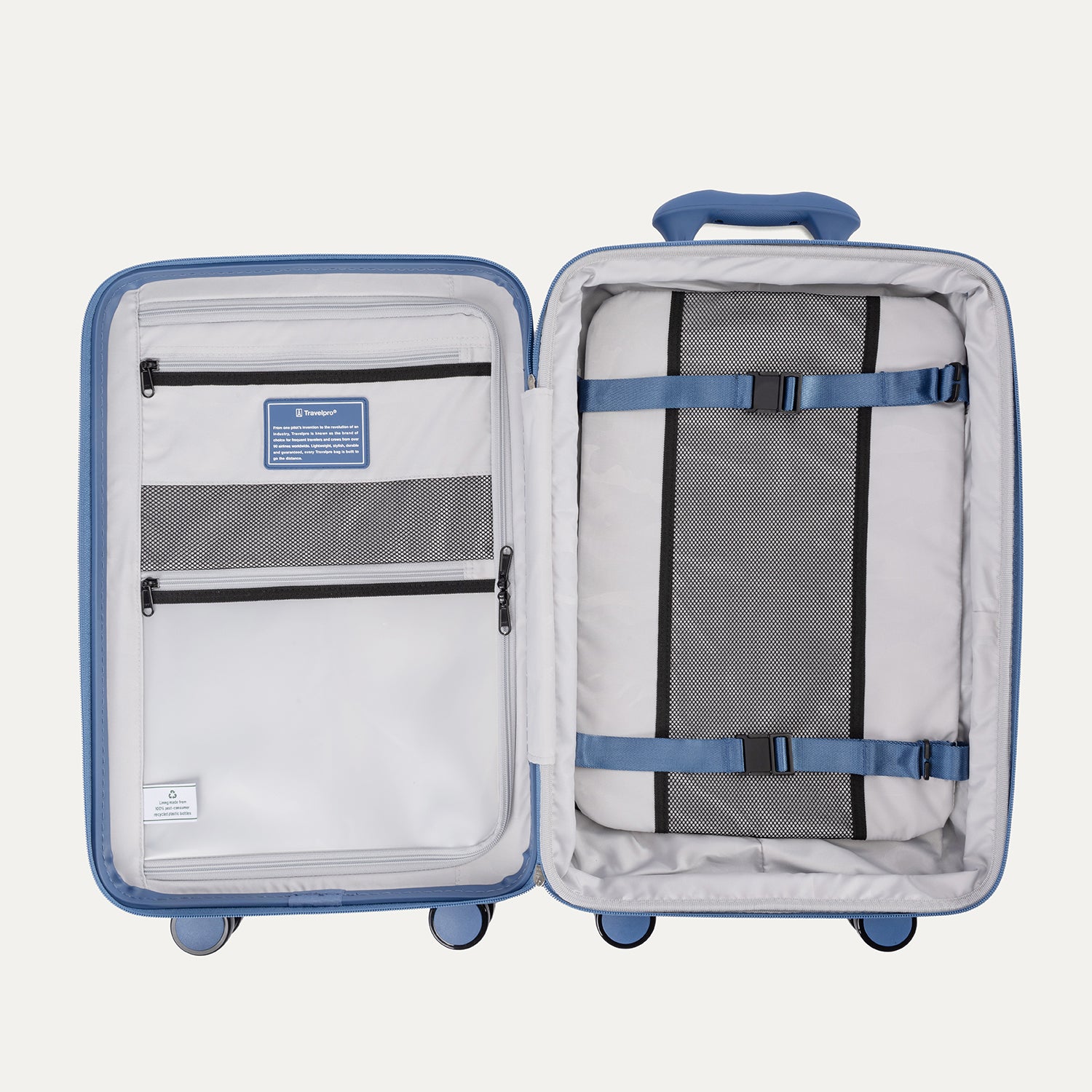 Open interior view of the Horizon Blue Optima Expandable Carry-on Spinner, showing the main packing compartment with a zippered mesh-paneled divider on the left and a removable multi-pocket organizer panel secured with compression straps on the right against a clean off-white background.