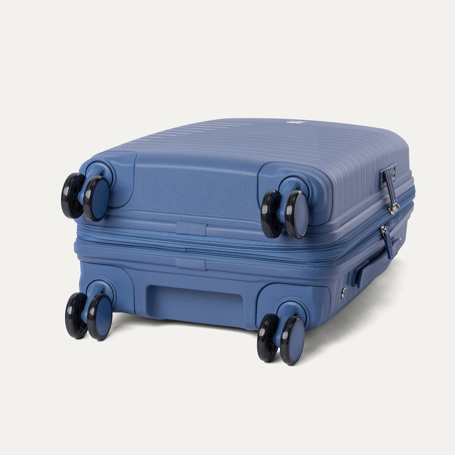 Bottom view of the Horizon Blue Optima Expandable Carry-on Spinner, highlighting the multi-directional spinner wheels and bottom grab handle against a light gray background.