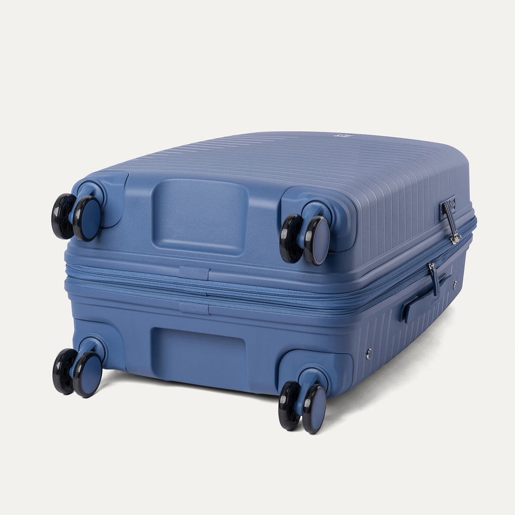 Blue suitcase with wheels on a light gray background