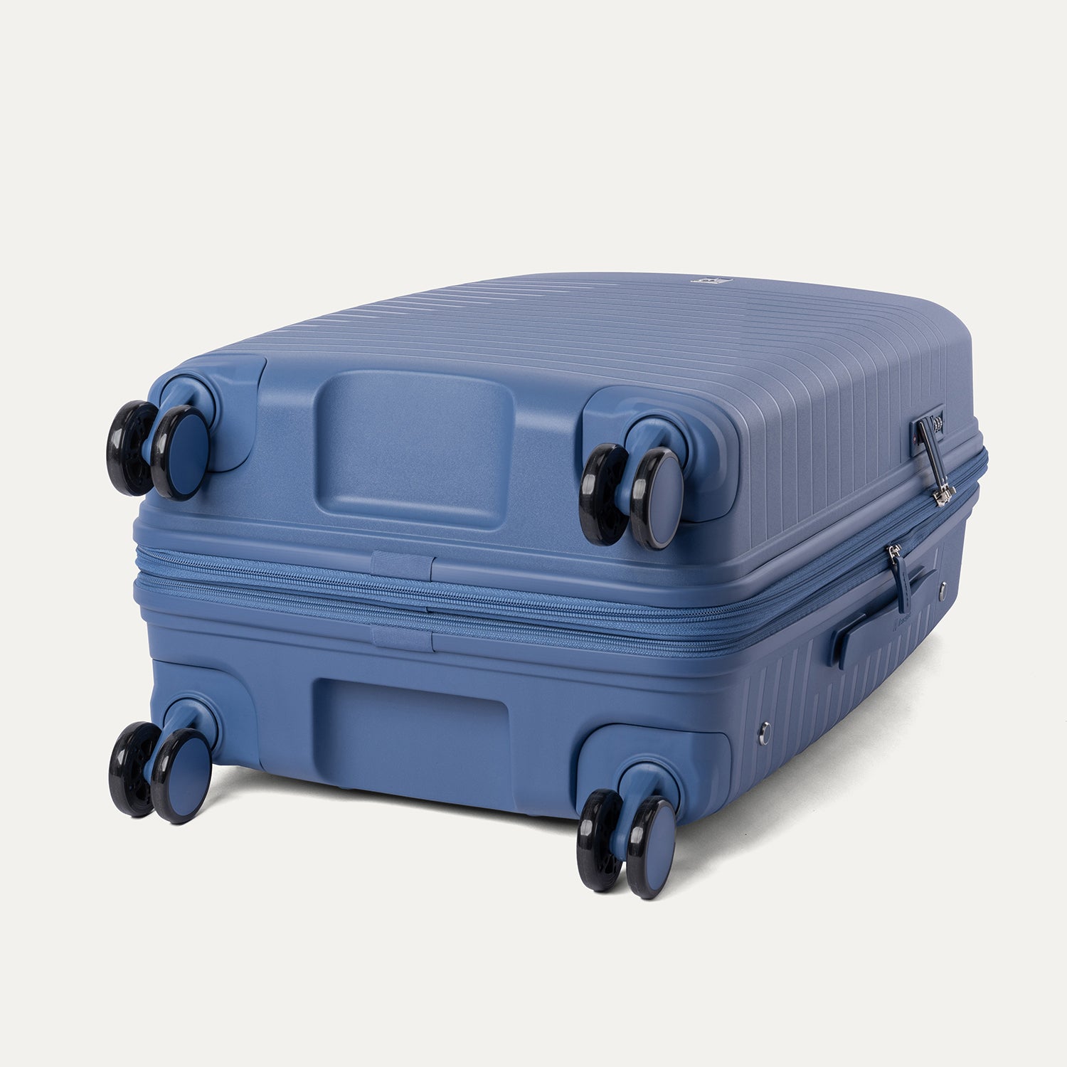 Blue suitcase with wheels on a light gray background