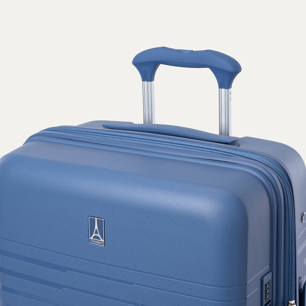 Blue suitcase with a handle on a light gray background