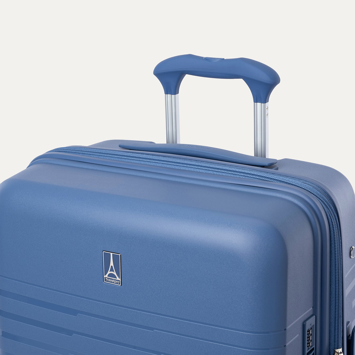Blue suitcase with a handle on a light gray background