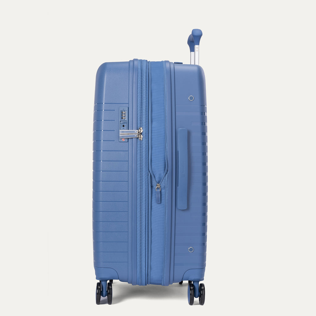Blue suitcase on a light gray background