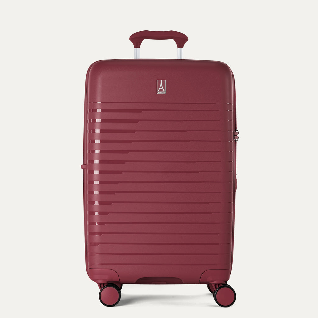 Red suitcase with a visible brand logo on a light gray background