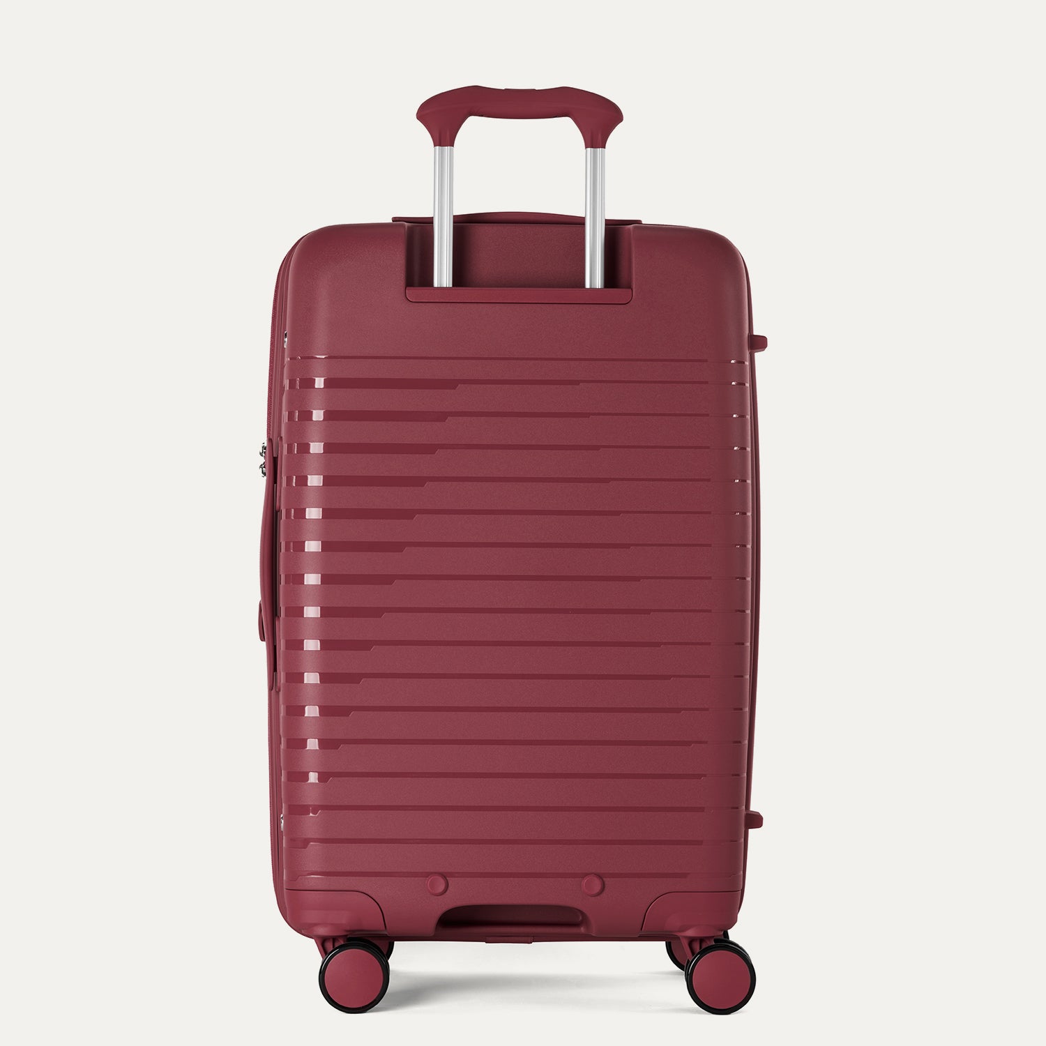 Maroon suitcase with a textured surface on a light gray background