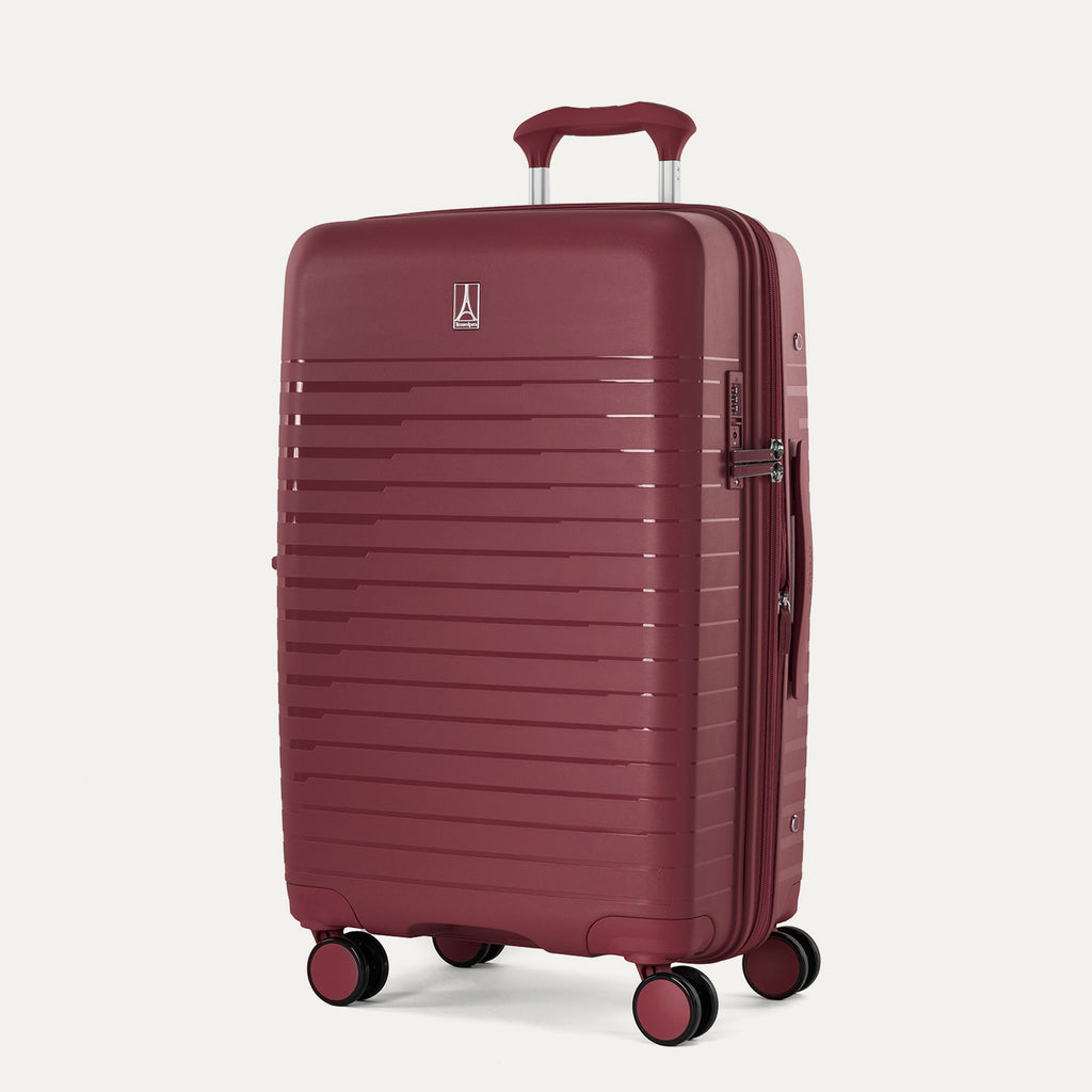 Maroon suitcase with a handle on a light gray background