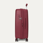 Maroon suitcase with wheels and handle on a light gray background