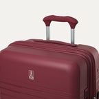 Maroon suitcase with handle on a light gray background