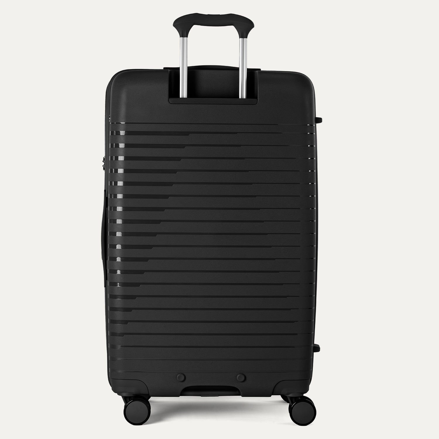 Black suitcase with a ribbed texture on a light gray background