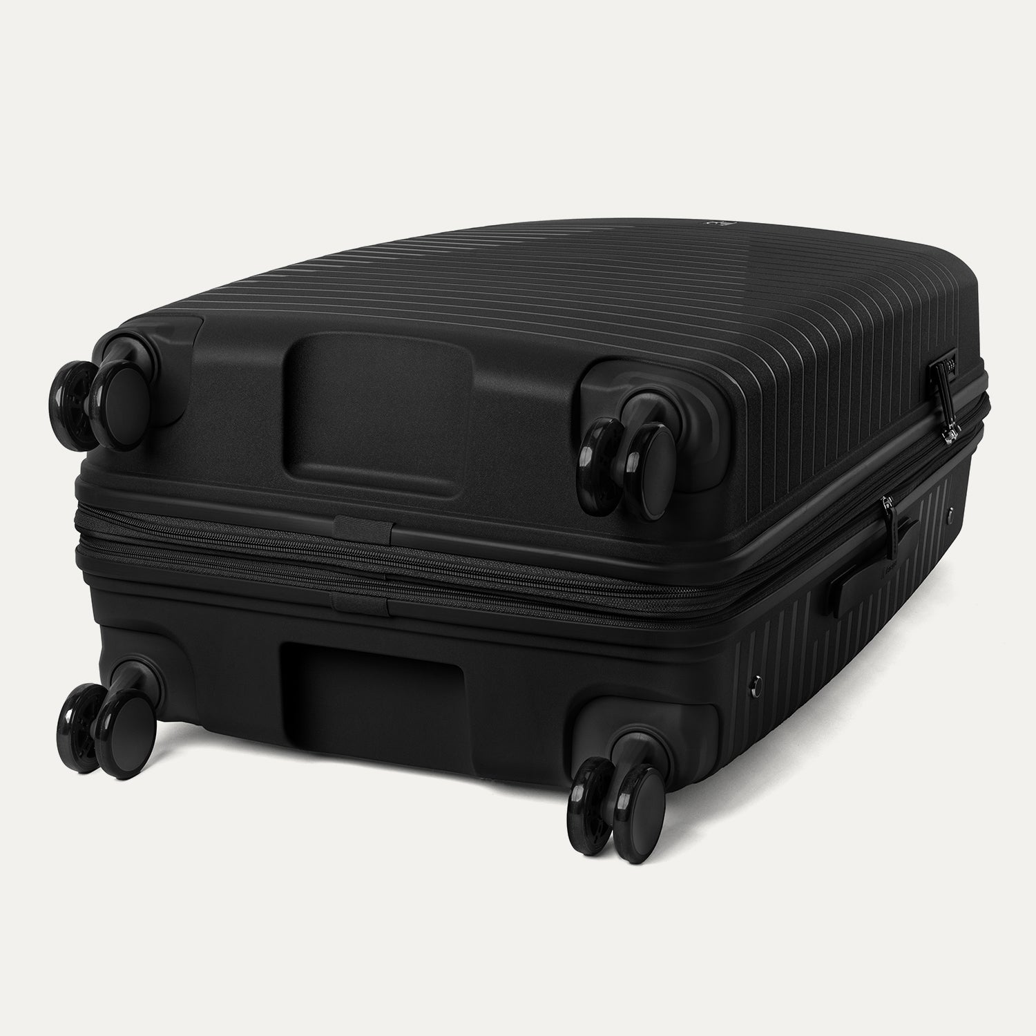 Black suitcase with wheels on a light gray background