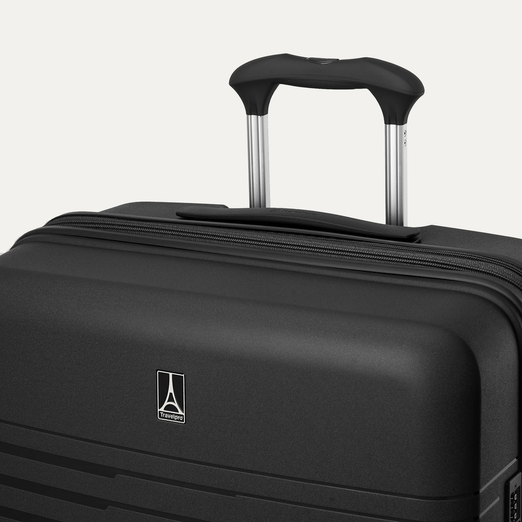 Black suitcase with a visible brand logo on a light gray background