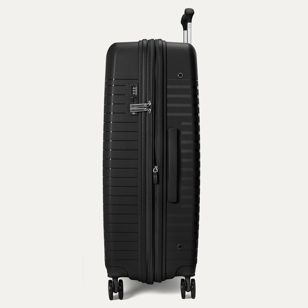 Black suitcase with wheels on a light gray background