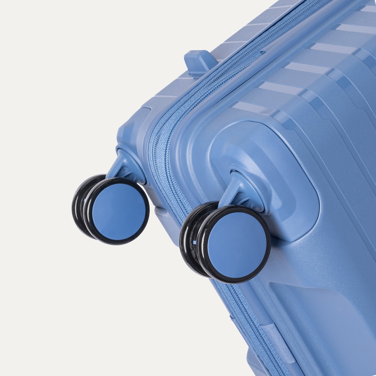 Blue suitcase with wheels on a light gray background