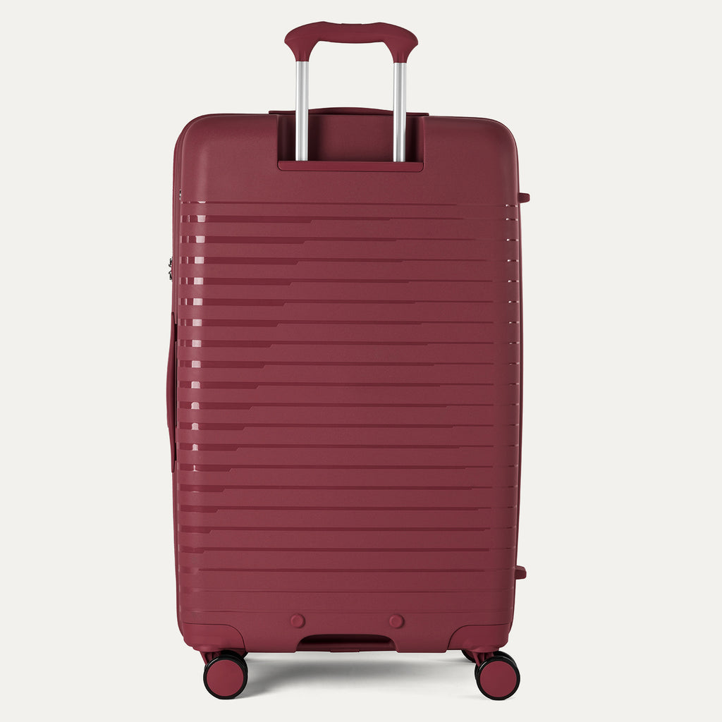 Red suitcase with a handle on a light gray background