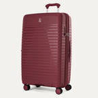 Maroon suitcase with wheels and handle on a light gray background