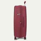 Maroon suitcase with wheels and handle on a light gray background