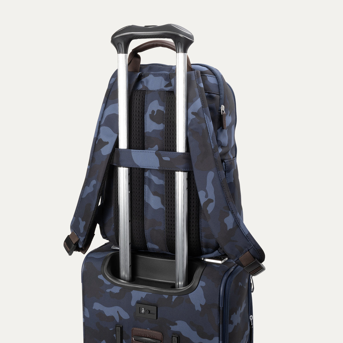 Rear view of the Travelpro Platinum Elite Slim Backpack secured on matching  Spinner in camouflage using rear stacking strap.
