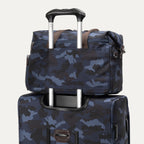 Rear view of the Travelpro Platinum Elite Underseat Tote Set in camouflage, secured to spinner handle via rear stacking strap.

