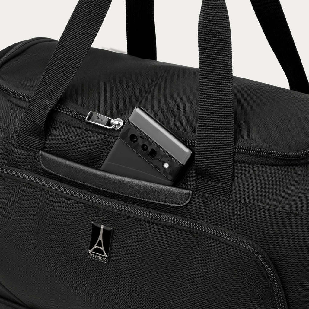 Black weekender with phone in QuickSlip™ pocket, featuring the Travelpro logo