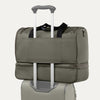 Green weekender bag with rear strap on a white background