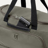 Green duffel bag with a phone inside a pocket, on a white background