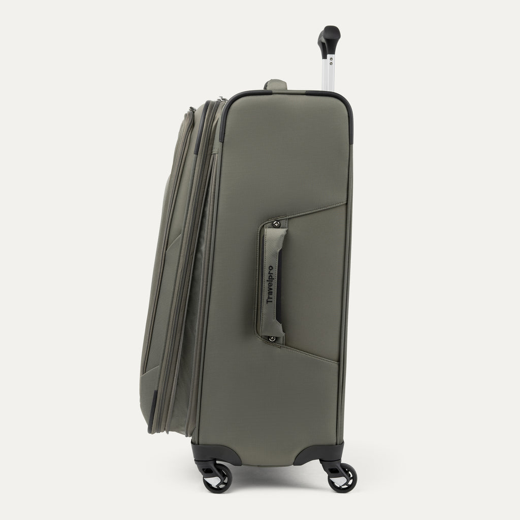 Side view of green suitcase with visible 'Travelpro' branding on a white background